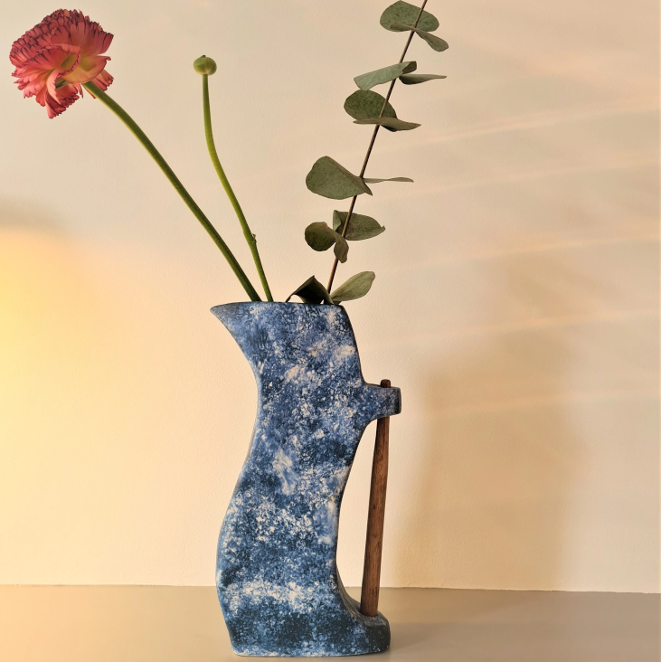 Blue ceramic vase with wooden handle